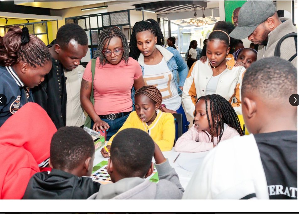Families and learners around a maths board game at the Fun STEM Camp grand finale in Nairobi