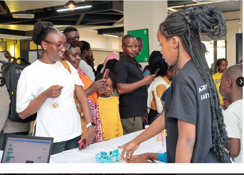A learner demonstrating her coded robot to parents at the Fun STEM Camp in Nairobi